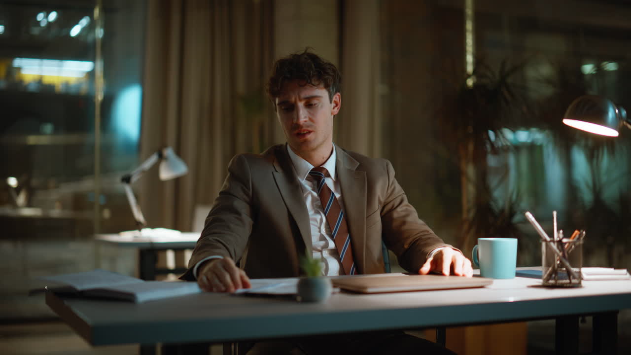 Shocked night businessman worried failed project closing laptop. Man stress