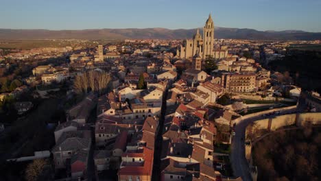Aerial-dolly-in-above-Segovia-medieval-Spanish-city-at-sunset-time
