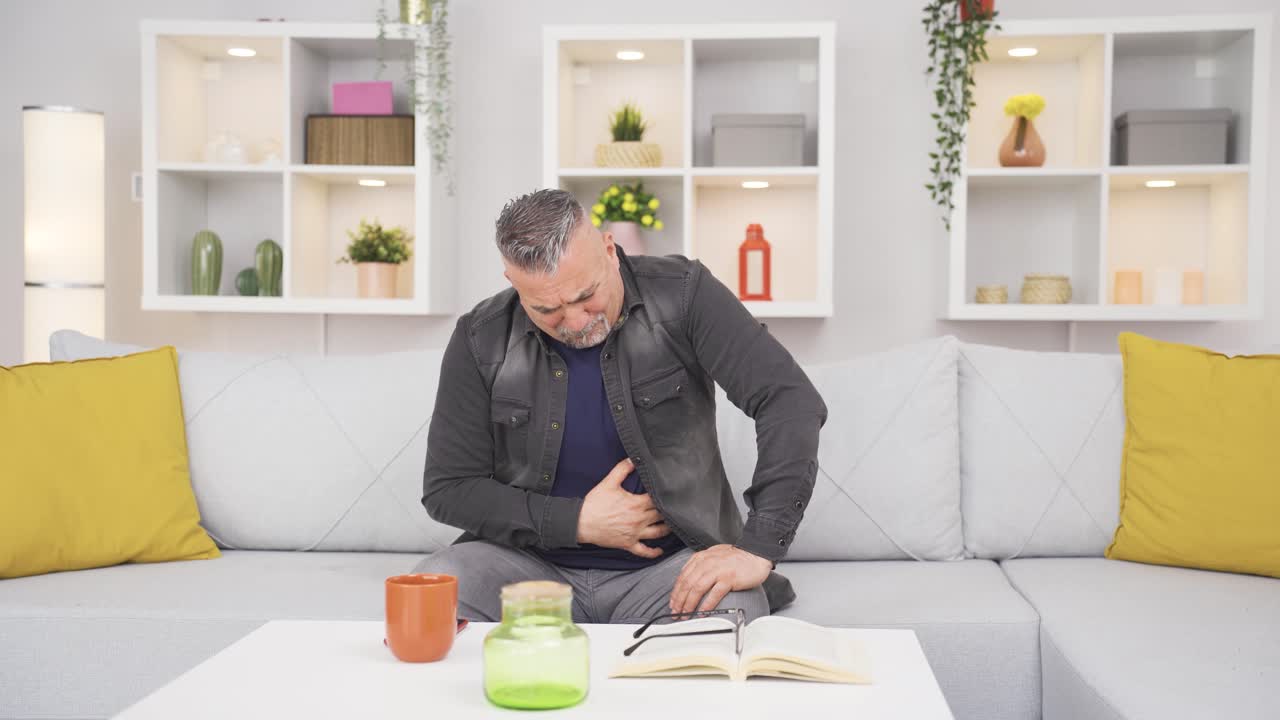 Old man experiencing stomachache.