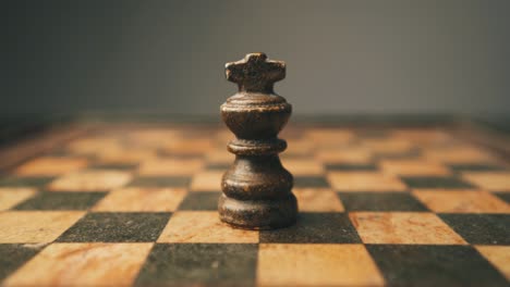 Chess-piece-black-king-being-placed-on-chess-board-close-up-shot