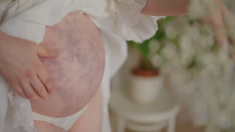 pregnant woman caressing belly in anticipation