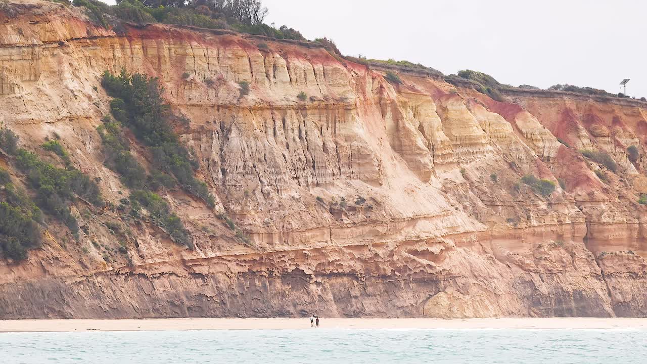 A serene view of rugged cliffs and ocean waves under soft daylight, capturing the natural beauty of Great Ocean Road