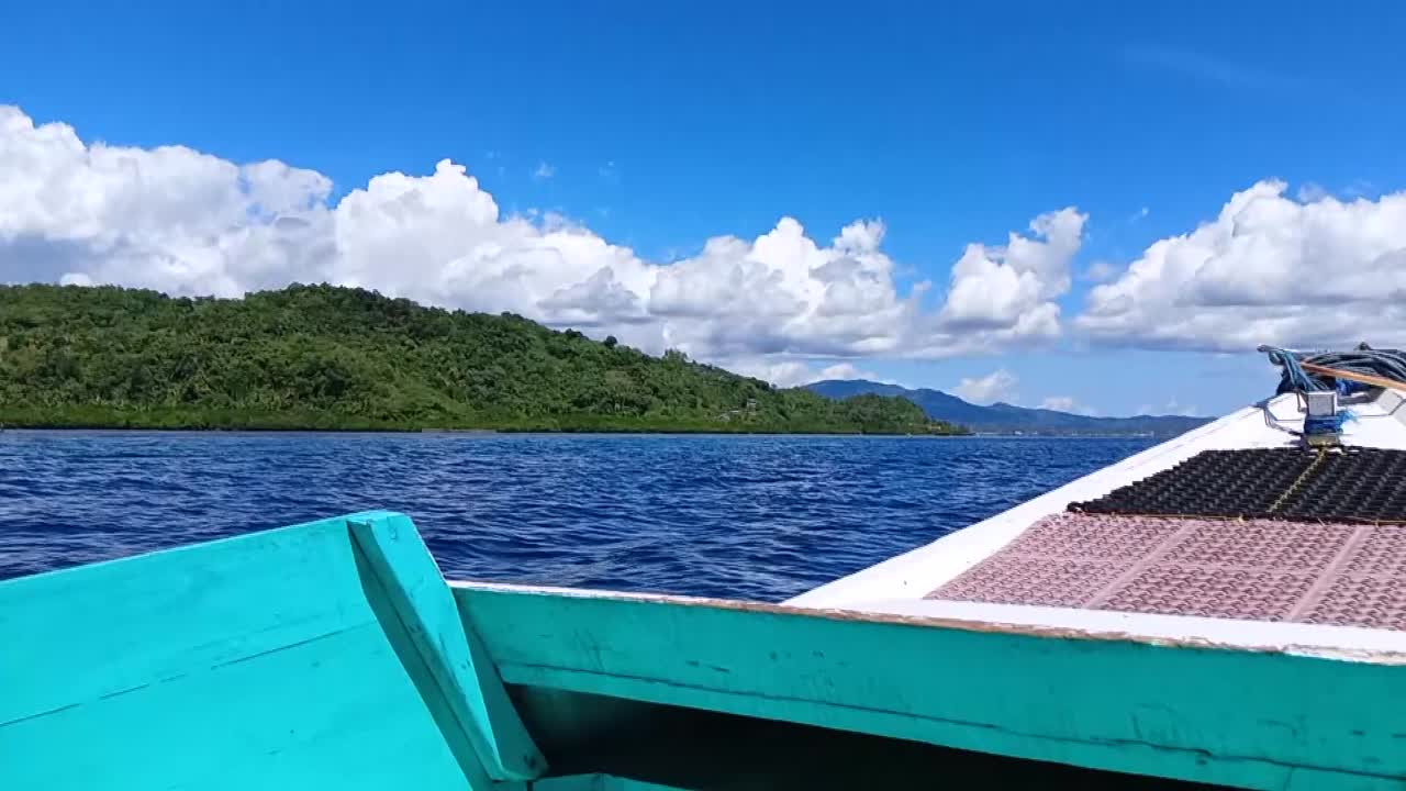 Boat sails in the sea waters on Karampuang Island, Mamuju, West Sulawesi