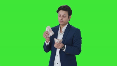 Indian-manager-counting-money-in-office-Green-screen