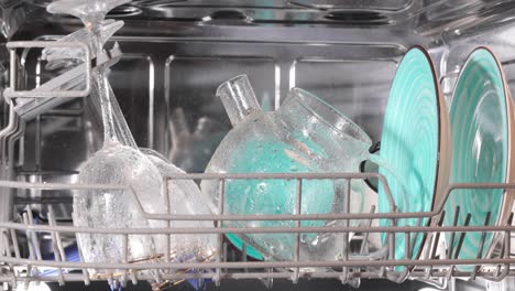 open dishwasher with clean dishes. housekeeping concept.