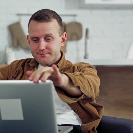 handsome man using laptop computer. young man with laptop computer working at home office