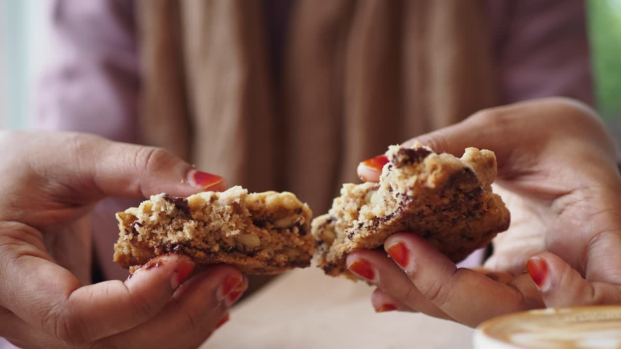 una mujer comiendo una galleta de chocolate