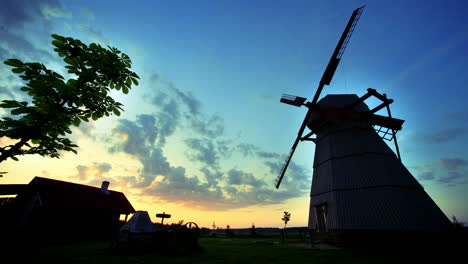 village sunrise timelapse. rural windmill silhouette. sunrise landscape