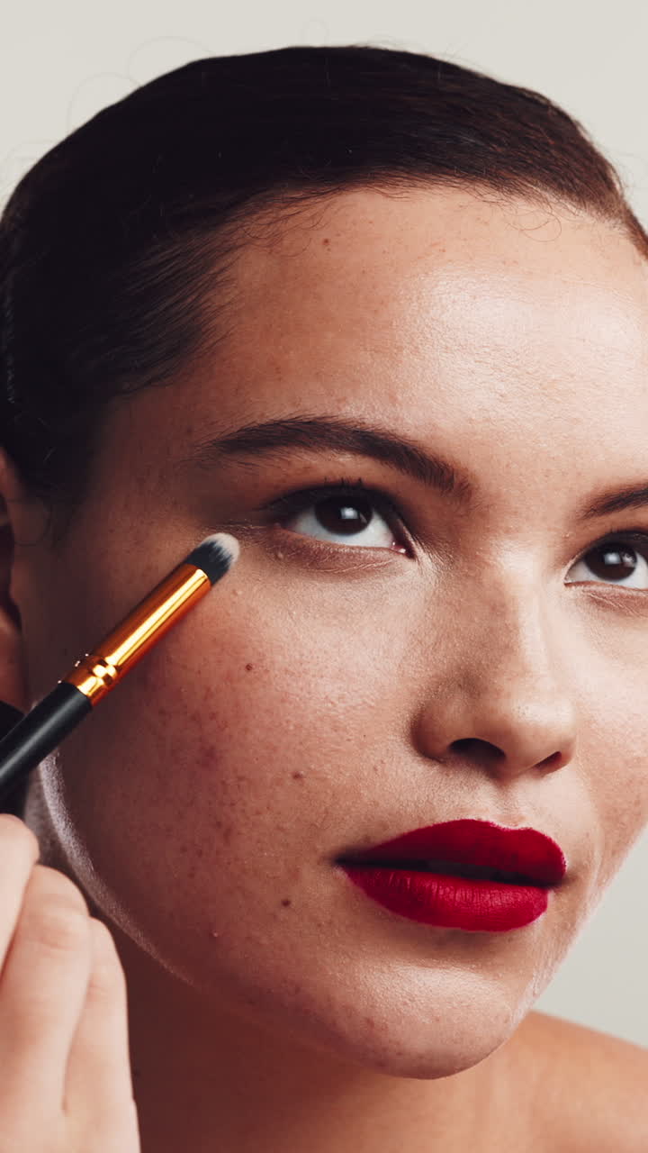 Woman Applying Eyeshadow with a Makeup Brush