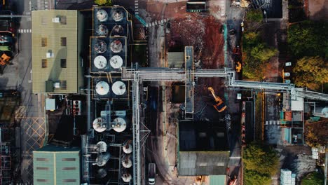 futuristic looking aerial drone footage, with a steampunk look with industrial buildings and vehicles