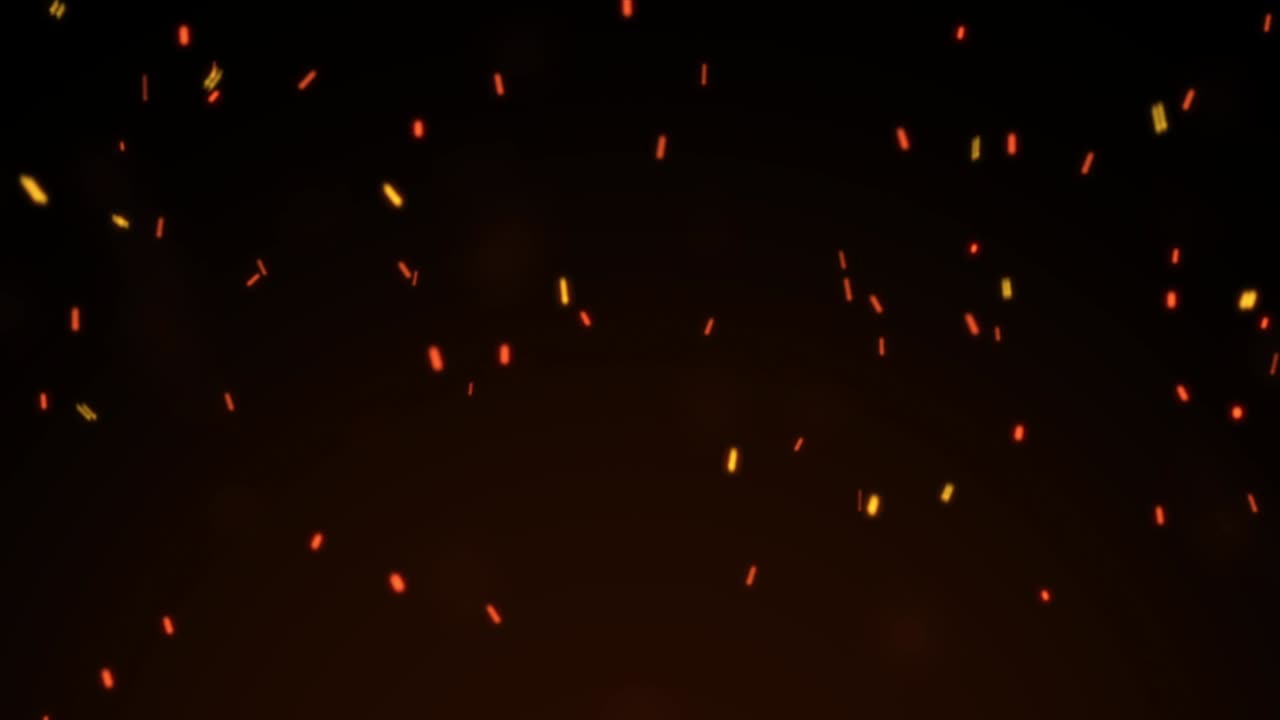 Burning red hot sparks flying from large fire flame on black background.