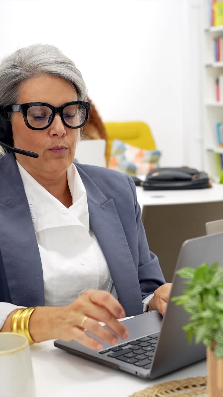 Professional Woman Working on Laptop with Headset