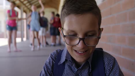 boy with glasses in the school corridor