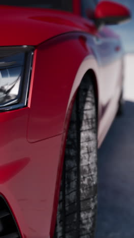 close up of a red car in the snow