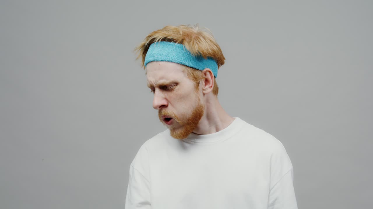 Man struggling with dumbbell workout