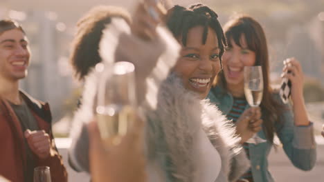 group of multiracial friends hanging out young african american woman dancing enjoying rooftop party at sunset drinking alcohol having fun on weekend celebration