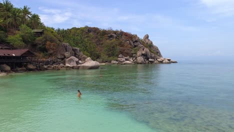 woman swimming in the turquoise waters of a tropical beach