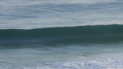 waves forming and crashing on the shore