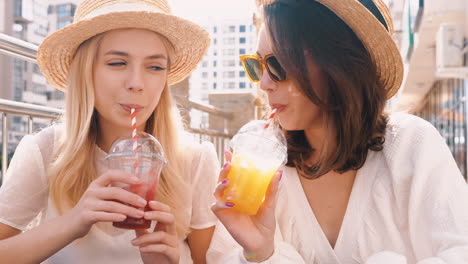 two friends enjoying drinks outdoors