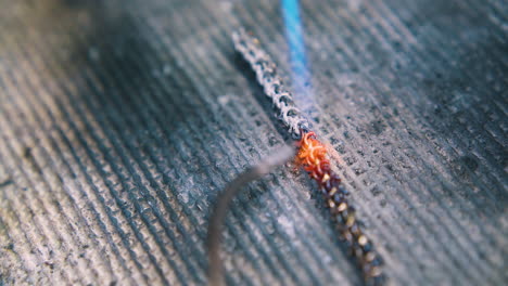 jeweler processes gold metal chain with gas burner closeup