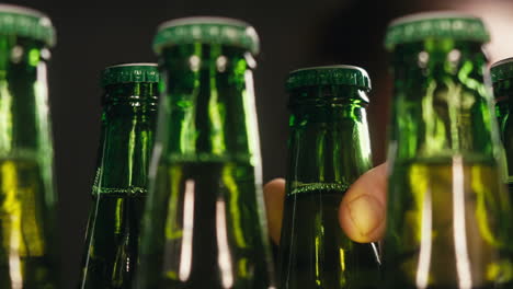 row of beer bottles in fridge, shop or hotel, cold lager craft german beer or cider, shop supermarket or wine cooler close up.
