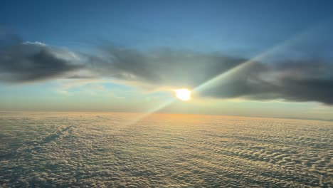 aerial view of a orange sky just before sunset, recorded from a jet cockpit