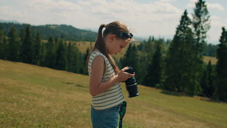 young girl photographer shooting landscape young photographer shooting landscape on beautifull green hillway taking pictures of nature girl filling the portfolio with amazing photos spending leisure time outdoor slow motion