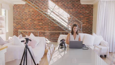 caucasian blogger woman doing  video montage at home