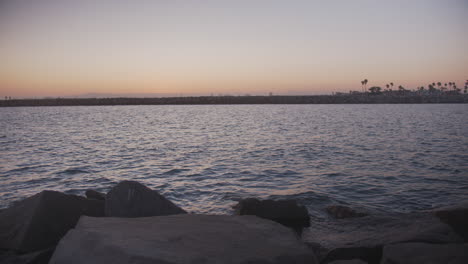 sunset over a long beach canal