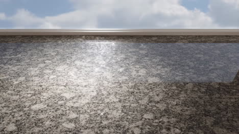 grey granite surface reflecting sky and clouds