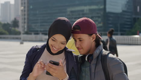 portrait happy multi ethnic friends using smartphone enjoying sunny day in city together browsing on mobile phone slow motion