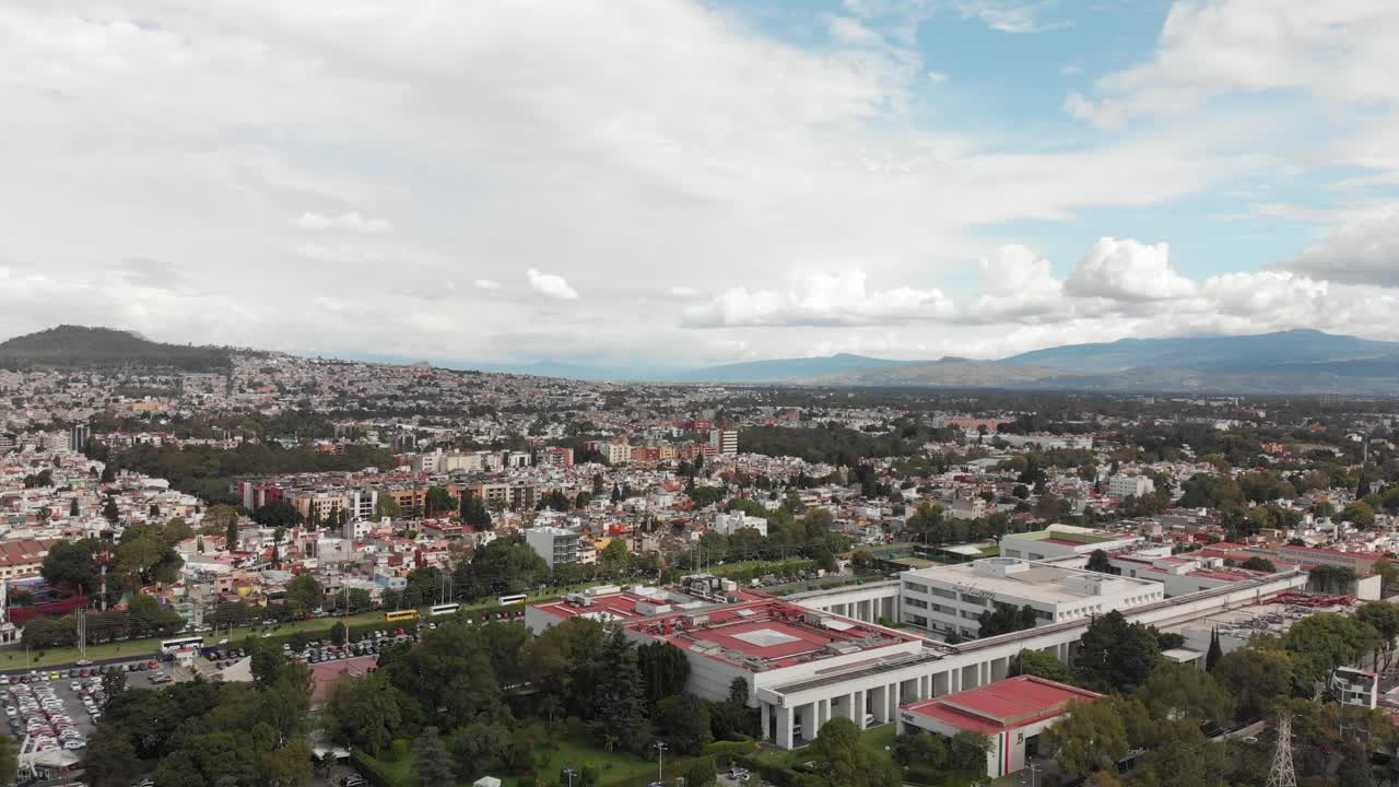 Drone view of a cloudy day, with blue sky, in Mexico City. Drone ascending slowly