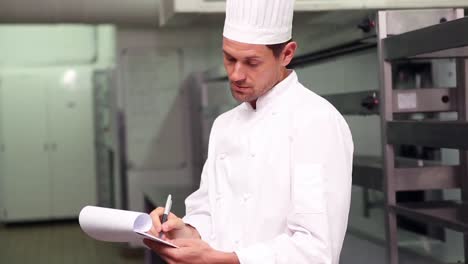 chef writing on clipboard