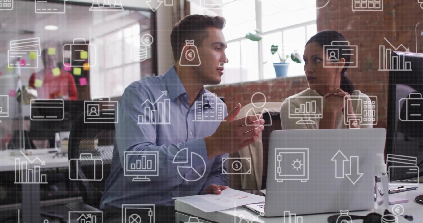 Man presenting docs and pointing, woman reviewing laptop while finance icons overlaying screen