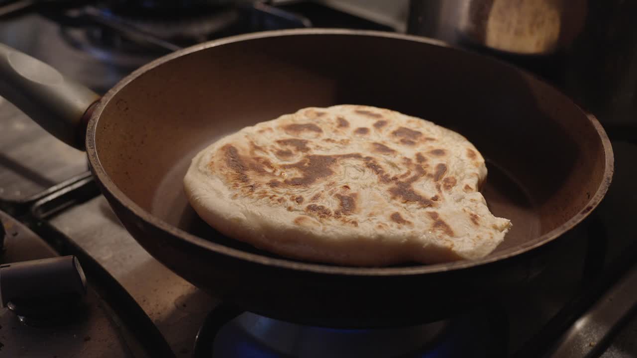 White flour bread baked at home in a pan until golden brown. Food preparation in the kitchen