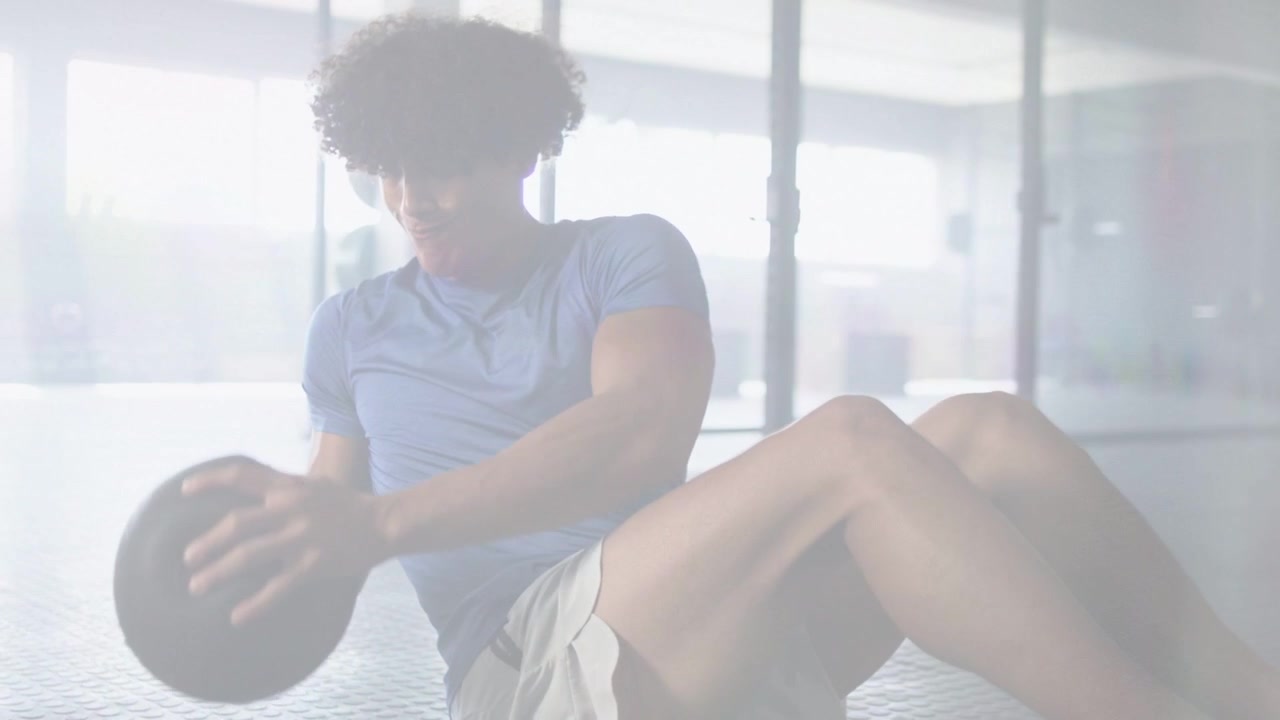 Man on fitness-hex floor raising med ball starting twisting reps for core with live counter showing