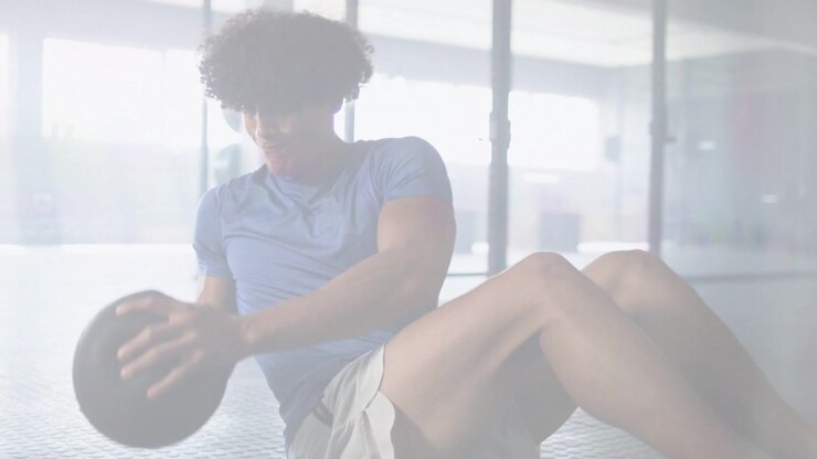 Man on fitness-hex floor raising med ball starting twisting reps for core with live counter showing