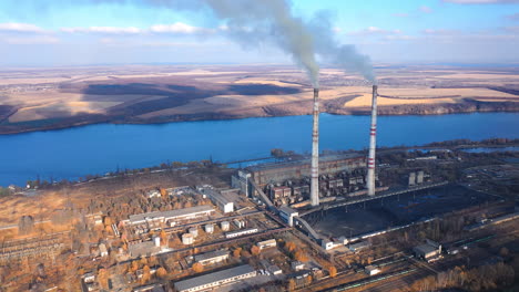 indusrty energy producing air pollution. aerial view of smoking factory tubes.