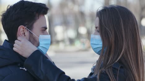 couple wearing masks outdoors