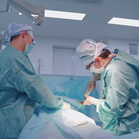 stem cells injection procedure. surgeon holding big syringe and injecting it to a patient in clinic. doctors performing operation in modern clinic.