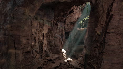 a cave with sunlight coming through the rocks