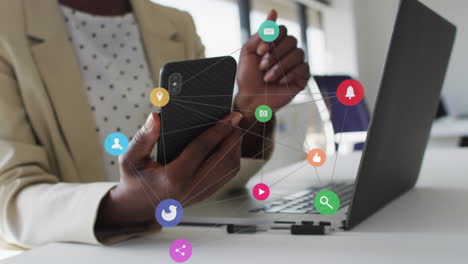 animation of network of digital icons over mid section of businesswoman using smartphone at office