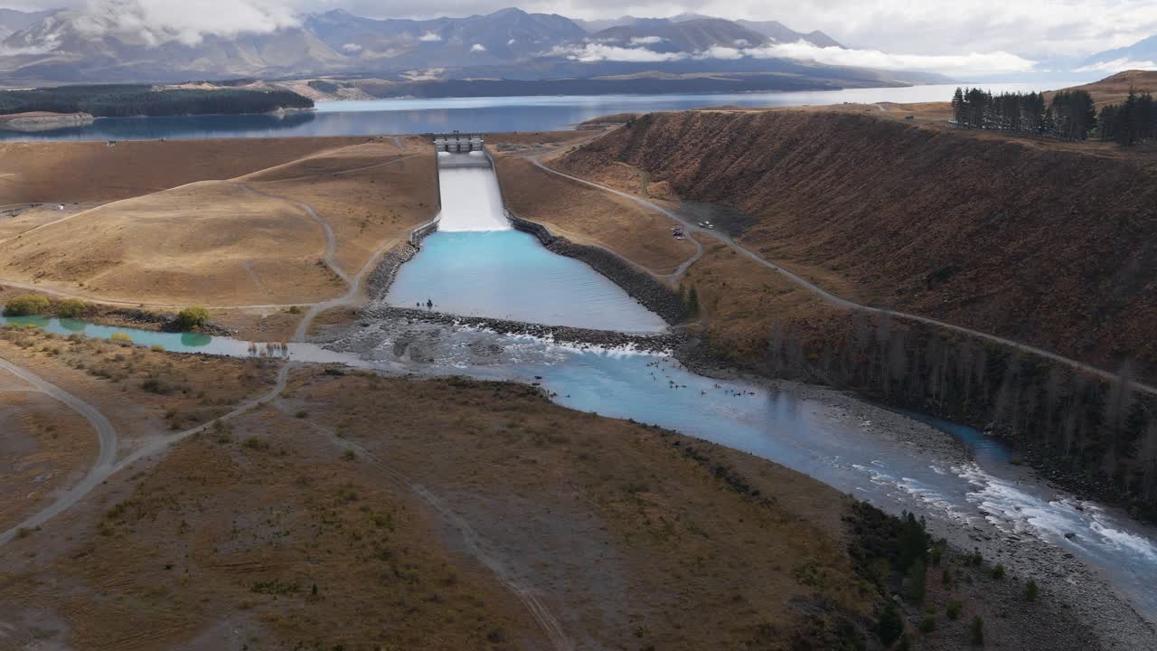 Open dam at Lake Pukaki feeding river with fresh glacial meltwater