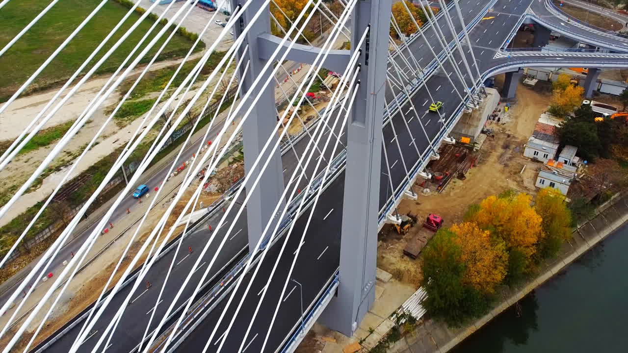 Ciurel passage, bridge over a river with moving cars, construction works near it. View from the drone. Bucharest, Romania