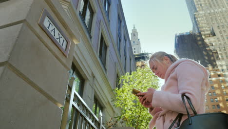 a woman orders a taxi uses a smartphone