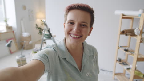 woman taking selfie in a room under renovation