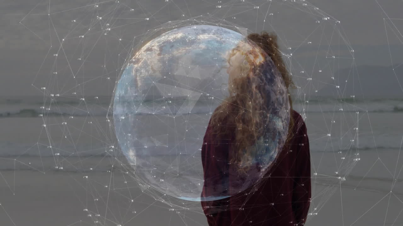 Standing on beach, person interacting with digital globe and network animation