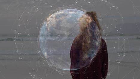 standing on beach, person interacting with digital globe and network animation