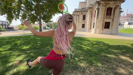 women playing in a park with beautiful architecture
