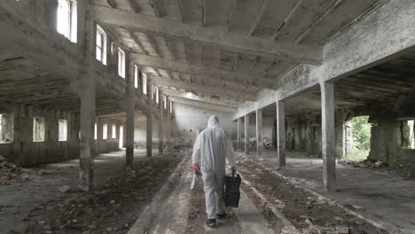 forensic specialist with a suitcase walks through the middle of an empty hall to the scene of a violent attack